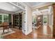 Open living space with hardwood floors, built-in bookshelves, and a stone fireplace at 14130 Lea Point Ct, Huntersville, NC 28078