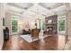 Bright and airy living room with a stone fireplace, coffered ceiling, and hardwood floors at 14130 Lea Point Ct, Huntersville, NC 28078