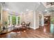 Sunlit living room with hardwood floors, large windows, and a view of the backyard at 14130 Lea Point Ct, Huntersville, NC 28078