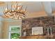 Unique antler chandelier and stone fireplace creating rustic elegance at 14130 Lea Point Ct, Huntersville, NC 28078
