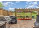 Wooden back deck featuring an outdoor grill, table with chairs, and partial pergola at 1424 River Dr, Belmont, NC 28012