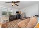 Functional bedroom with a futon, ceiling fan, and organized storage shelves by the window at 1424 River Dr, Belmont, NC 28012