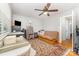 Cozy bedroom with a patterned rug, futon, ceiling fan, and built-in shelving at 1424 River Dr, Belmont, NC 28012
