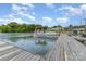 This photo shows a boat dock on the water with a pontoon boat and a beautiful sky with fluffy clouds at 1424 River Dr, Belmont, NC 28012
