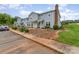 Townhome with front yard features a tidy front yard, steps leading to the entrance, and a cozy bench at 1424 River Dr, Belmont, NC 28012