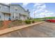 Exterior view of a townhome with front yard, parking area, and proximity to surrounding amenities at 1424 River Dr, Belmont, NC 28012