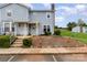 Townhome exterior features a well-maintained front yard, steps leading to the entrance, and a cozy bench at 1424 River Dr, Belmont, NC 28012