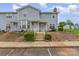 Charming townhome featuring a tidy front yard, steps leading to the entrance, and a welcoming porch at 1424 River Dr, Belmont, NC 28012