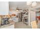 Eat-in kitchen with tiled floor and backsplash, white cabinets, and view into living area at 1424 River Dr, Belmont, NC 28012