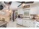 Eat-in kitchen with white cabinets, tile backsplash, and sliding glass doors to rear deck at 1424 River Dr, Belmont, NC 28012