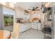 Bright eat-in kitchen with white cabinets, tile flooring, and stainless steel refrigerator at 1424 River Dr, Belmont, NC 28012