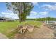 A serene lakeside view with mature trees, a boat trailer, and a glimpse of the dock at 1424 River Dr, Belmont, NC 28012