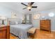 Comfortable main bedroom featuring a bed, wood floors, a dresser, and ceiling fan at 1424 River Dr, Belmont, NC 28012