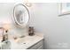 Well-lit powder room featuring a mirror, vanity, a decorative lamp, and light colored finishes at 1424 River Dr, Belmont, NC 28012