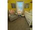 Cozy Bedroom featuring a crib, glider, and whimsical animal artwork creating a cheerful atmosphere at 15003 Jerpoint Abby Dr, Charlotte, NC 28273