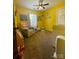 Yellow Bedroom with neutral glider, baby furniture and window providing natural light at 15003 Jerpoint Abby Dr, Charlotte, NC 28273
