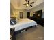 Large bedroom featuring a ceiling fan, television, large bed, black dressers, and a door leading outside at 15003 Jerpoint Abby Dr, Charlotte, NC 28273