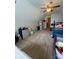 Bonus room features a ceiling fan, beds, a play tent and a dollhouse at 15003 Jerpoint Abby Dr, Charlotte, NC 28273