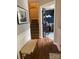 Inviting foyer with hardwood floors, a staircase, and an office space featuring elegant glass doors at 15003 Jerpoint Abby Dr, Charlotte, NC 28273