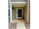 Welcoming front entrance with a black door, sidelight window, and decorative stone landscaping at 15003 Jerpoint Abby Dr, Charlotte, NC 28273