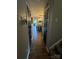 Hallway with hardwood floors and views of the kitchen and living area at 15003 Jerpoint Abby Dr, Charlotte, NC 28273
