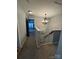 Upstairs hallway featuring a decorative light fixture, baby gate, and an open doorway leading to a room at 15003 Jerpoint Abby Dr, Charlotte, NC 28273