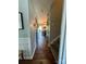 Hallway view with wood-look flooring leading to a kitchen and staircase at 15003 Jerpoint Abby Dr, Charlotte, NC 28273