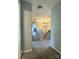 Carpeted hallway with views of an ornate chandelier and stairwell at 15003 Jerpoint Abby Dr, Charlotte, NC 28273