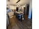 A well-lit kitchen with a navy island, pendant lighting, granite countertops, and stainless appliances at 15003 Jerpoint Abby Dr, Charlotte, NC 28273
