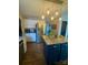 Well-equipped kitchen with stainless steel appliances, granite countertops, a blue island, and stylish pendant lighting at 15003 Jerpoint Abby Dr, Charlotte, NC 28273