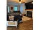 Comfortable living room with a fireplace, ceiling fan, and hardwood floors throughout at 15003 Jerpoint Abby Dr, Charlotte, NC 28273