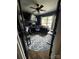 Well-organized home office with dark blue walls, a ceiling fan, and a patterned rug at 15003 Jerpoint Abby Dr, Charlotte, NC 28273
