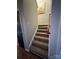 Carpeted stairway with a wooden handrail and a glimpse of a nearby door at 15003 Jerpoint Abby Dr, Charlotte, NC 28273