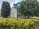 Neighborhood corner street sign with manicured bushes and landscaping at 15003 Jerpoint Abby Dr, Charlotte, NC 28273