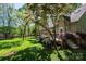 Home's deck is surrounded by green lawn and foliage at 1524 Court Cir, Newton, NC 28658