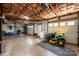 Unfinished basement featuring concrete floors, exposed ceiling, and garage door access at 1524 Court Cir, Newton, NC 28658