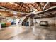Unfinished basement with a car and lawn tractor featuring concrete floors and exposed ceiling at 1524 Court Cir, Newton, NC 28658