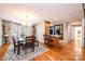 Spacious dining area adjacent to kitchen; features hardwood floors, a stylish chandelier, and natural light at 1524 Court Cir, Newton, NC 28658