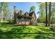 Charming stone-accented home featuring a cozy front porch and well-manicured lawn at 1524 Court Cir, Newton, NC 28658