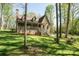 Charming stone-accented home with a cozy front porch surrounded by lush greenery at 1524 Court Cir, Newton, NC 28658