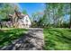 Spacious home with a long driveway leading to an attached garage, surrounded by mature trees at 1524 Court Cir, Newton, NC 28658