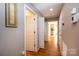 Hallway featuring hardwood floors, neutral paint, and access to multiple rooms at 1524 Court Cir, Newton, NC 28658