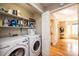 Well-organized laundry room with shelving, storage, and modern washer and dryer at 1524 Court Cir, Newton, NC 28658