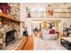 Cozy living room featuring a stone fireplace, hardwood floors, and an open layout to the dining area at 1524 Court Cir, Newton, NC 28658