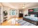 Bright main bedroom with hardwood floors, ceiling fan, and a large window offering ample natural light at 1524 Court Cir, Newton, NC 28658