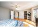 This main bedroom features hardwood floors, a ceiling fan, walk-in closets, and access to the laundry room at 1524 Court Cir, Newton, NC 28658