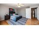 This main bedroom features hardwood floors, a ceiling fan, and an ensuite bathroom with a walk-in closet at 1524 Court Cir, Newton, NC 28658