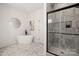 Spa-like bathroom features a modern soaking tub, stand up glass shower, and marbled tile at 15906 Youngblood Rd, Charlotte, NC 28278