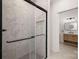Contemporary bathroom features a tiled glass shower and a vanity with storage at 15906 Youngblood Rd, Charlotte, NC 28278