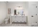 Well-lit bathroom features double sink vanity, marbled floors, and contemporary fixtures at 15906 Youngblood Rd, Charlotte, NC 28278